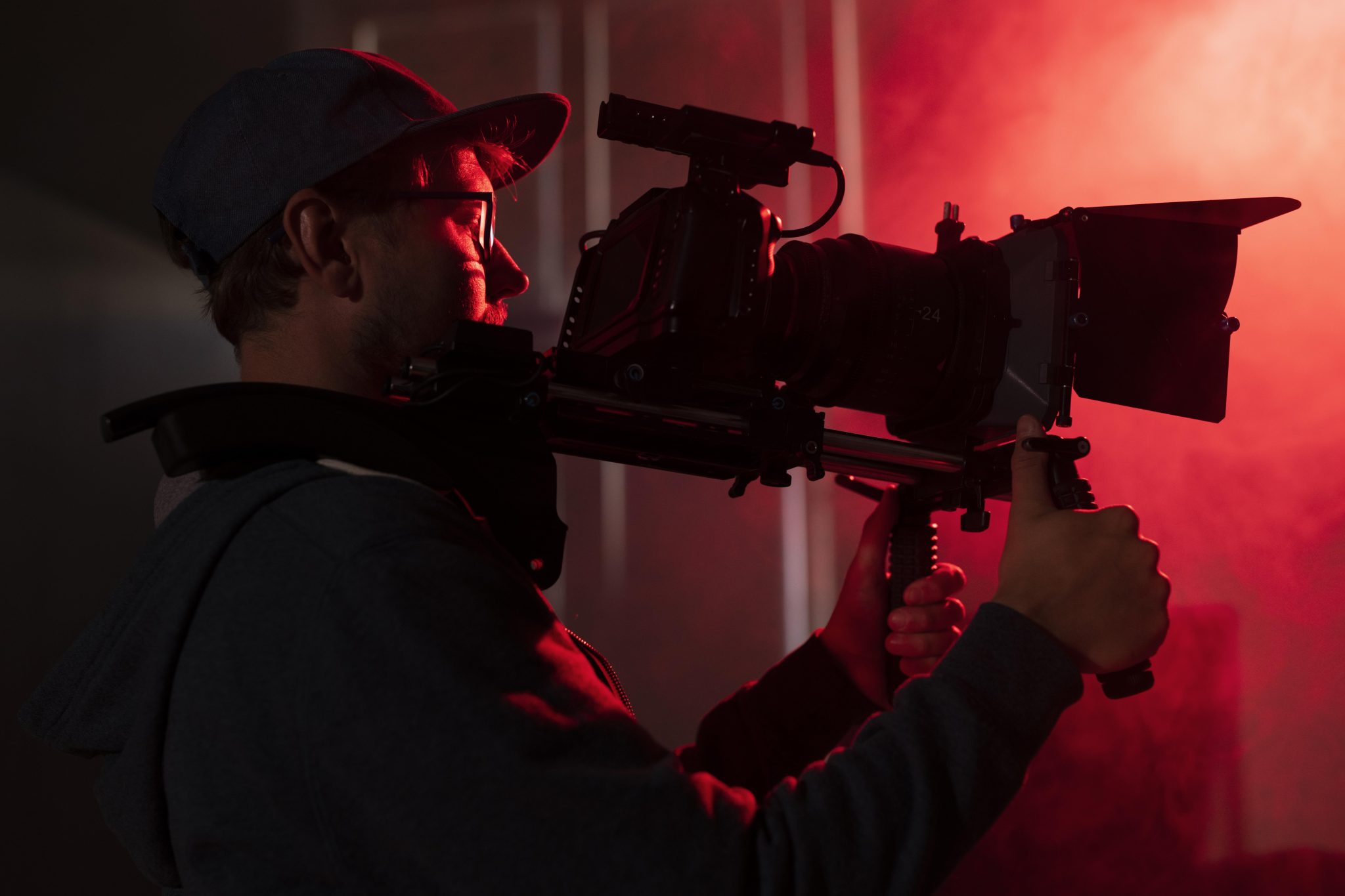 photo of man filming with professional camera