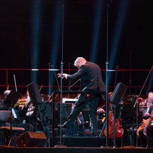 photo of a large orchestra on stage signifying the relationship between video and it's individual parts