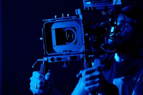 photo camera operators holding a camera
